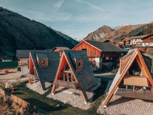 an overhead view of a group of houses with mountains in the background at Collis Hill Chalets & Hotel in Kals am Großglockner