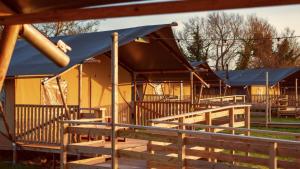 a group of houses with a blue tent at The Camp at The Wave in Bristol +2 photos