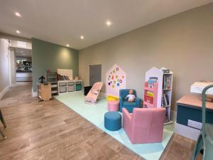 a living room with a play room with a toy room at The Pigs' Pantry, Burley in Burley