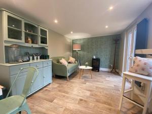 a living room with a couch and a table at The Pigs' Pantry, Burley in Burley