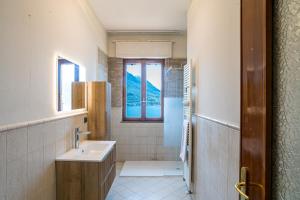 a bathroom with a sink and a window at Villa Panoramica in Perledo