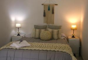 a bedroom with a large bed with two lamps at Lo de Ine in La Cumbre