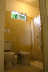 a bathroom with a toilet and a sink at Lo de Ine in La Cumbre