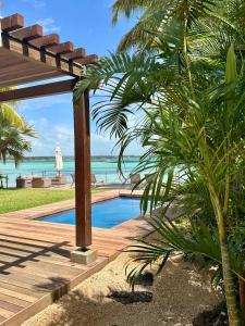 a resort swimming pool with a view of the ocean at Ruby in Post of Flacq