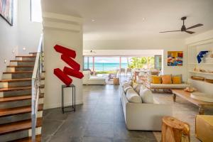 a living room with a couch and a staircase at Ruby in Post of Flacq +36 photos