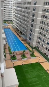 an overhead view of a large building with a swimming pool at Tower1 Smdc green2 Dasmarinas in Dasmariñas