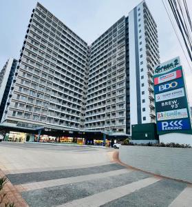 a large building with a sign in front of it at Tower1 Smdc green2 Dasmarinas in Dasmariñas +6 photos