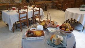 a table with a buffet of food on it with two tables at La Tilia in Saint-Riquier