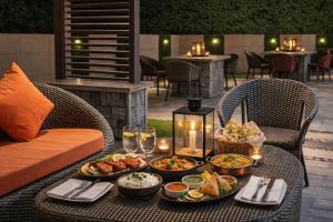 a table with plates of food on a patio at Hotel LA Eden in Mussoorie