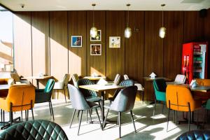 a restaurant with tables and chairs in a room at MY HOTEL in Prizren