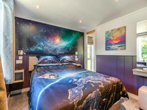 a bedroom with a large universe mural on the wall at Cranbourne Chase Stargazer - Ukc6914 in Pentridge