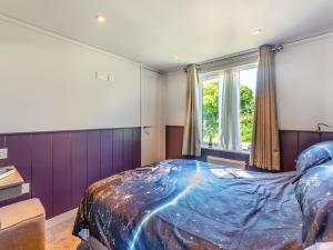 a bedroom with a large bed with a blue comforter at Cranbourne Chase Stargazer - Ukc6914 in Pentridge +8 photos