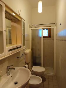 a bathroom with a sink and a toilet and a shower at La Yucca in Dolceacqua