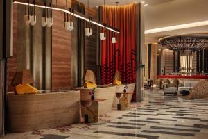 a lobby of a hotel with tables and chairs at W Riyadh - KAFD in Riyadh