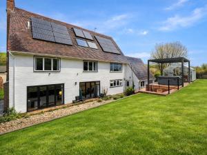 a house with solar panels on the roof at Blackthorn House in Blandford Forum