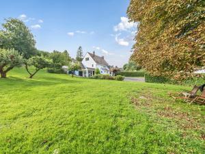a house on a grassy hill with a yard at Blackthorn House in Blandford Forum