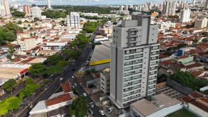 an aerial view of a city with a tall building at Apartamento 85 - Friends in Ribeirão Preto