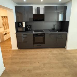 a kitchen with stainless steel appliances in a room at Schalke Unterkunft in Gelsenkirchen