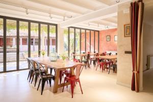 a dining room with tables and chairs and windows at Casa Rural Las Bengoas in Alesanco
