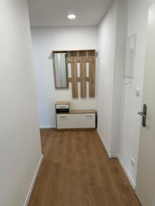 a hallway with white walls and a wooden floor at Schalke Unterkunft in Gelsenkirchen +2 photos