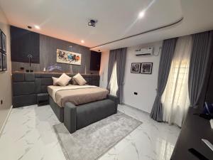 a bedroom with a bed and a couch at House 9 Signature in Port Harcourt +19 photos