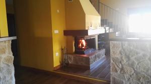 a stone fireplace in a room with a staircase at Casa rural Miranda in Salamanca