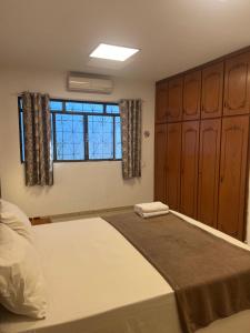 a bedroom with a large bed and a window at Morada da Lua in Foz do Iguaçu