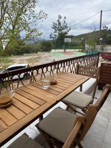 a wooden table and chairs sitting on a patio at Sea View Chic Apartment in Karianí