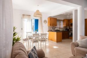 a kitchen and dining room with a table and chairs at Dream Olea Villa - Ayia Napa in Ayia Napa