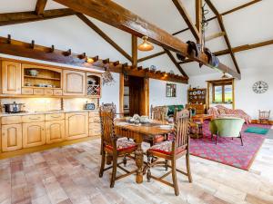 a kitchen and dining room with a wooden table and chairs at The Barton in Launceston +20 photos