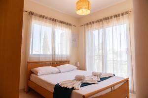 a bedroom with a bed with towels on it at Dream Olea Villa - Ayia Napa in Ayia Napa +58 photos