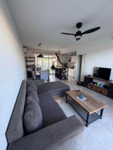 a living room with a couch and a table at Beautiful fully-equipped duplex in Ezeiza