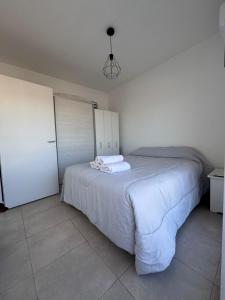 a bedroom with a large white bed in a room at Beautiful fully-equipped duplex in Ezeiza +3 photos