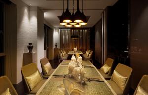 a dining room with a long table and chairs at Gloria Manor in Kenting