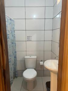 a small bathroom with a toilet and a sink at Morada da Lua in Foz do Iguaçu