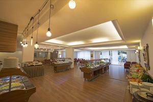 a large room with tables and chairs in a building at Sunbay Park Hotel in Marmaris