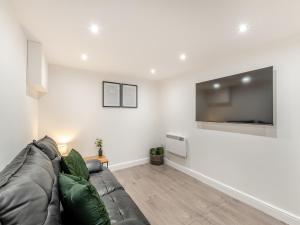a living room with a couch and a flat screen tv at The Bunker - Uk40225 in Bardon Mill