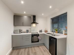 a kitchen with a sink and a stove top oven at The Bunker - Uk40225 in Bardon Mill