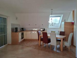 a kitchen with a table and chairs and a dining room at Haus Seeblick in Jettingen-Scheppach