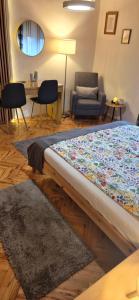 a bed in a room with a couch and a chair at House Dado in Jezerce