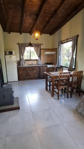 a living room with a table and chairs and a kitchen at Cabañas Altos de San Blas in San Javier