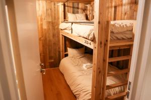a bunk bed room with two bunk beds at Aburatsu Inn Kadocco in Nichinan