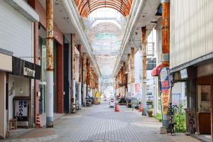 an empty hallway of a building with an arcade at Aburatsu Inn Kadocco in Nichinan