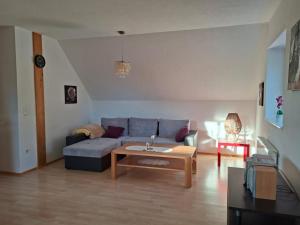 a living room with a couch and a table at Haus Seeblick in Jettingen-Scheppach
