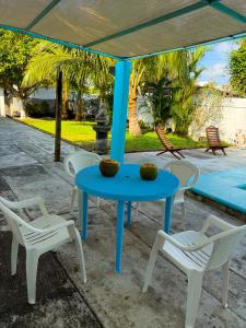 a blue table and white chairs under a tent at Casa de las Iguanas Tecolutla in Tecolutla