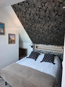 a bedroom with a large bed with a black headboard at Gîtes et Chambres des Coteaux in Sainte-Maure-de-Touraine +37 photos