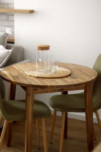 a wooden table with glasses on top of it at Not A Hotel Cesis in Cēsis