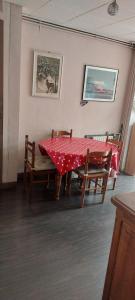 a table and chairs with a red table cloth on it at Maison de ville in Rouen