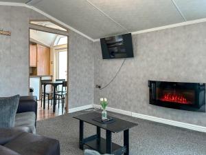 a living room with a couch and a fireplace at The Meadow - Uk51411 in Brechin
