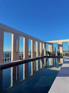 a view of a building with a swimming pool at JOST Hôtel Bordeaux Centre Gare Saint Jean in Bordeaux